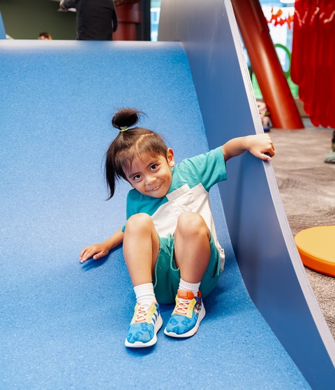 Child going down slide