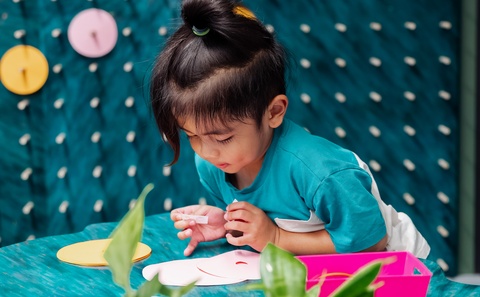 Child crafting at craft station