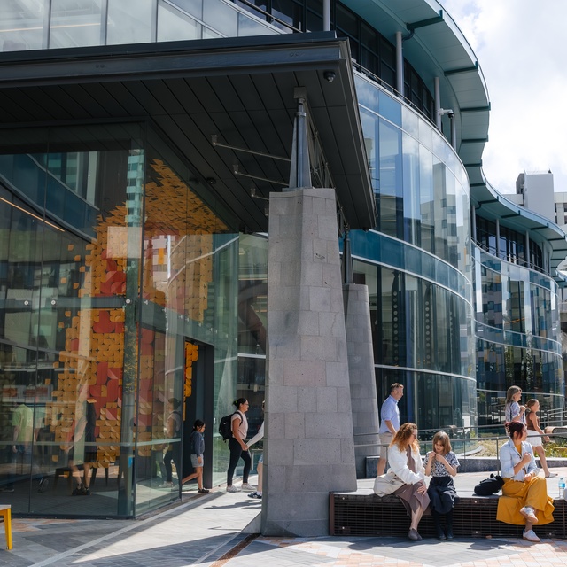 people sitting outside building, or exiting building