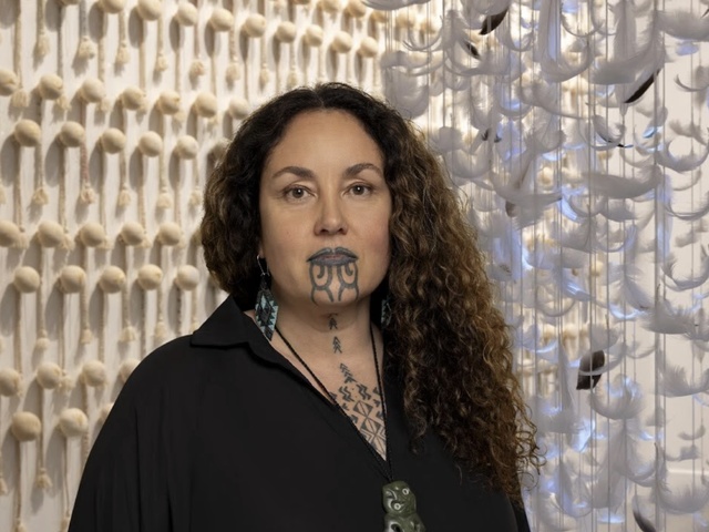 Lady artist in front of artwork